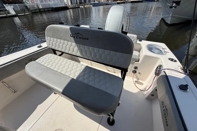 Slide: The Image of 2025 Sea Chaser 22 HFC boat interior with cushioned seating and water view. - 13