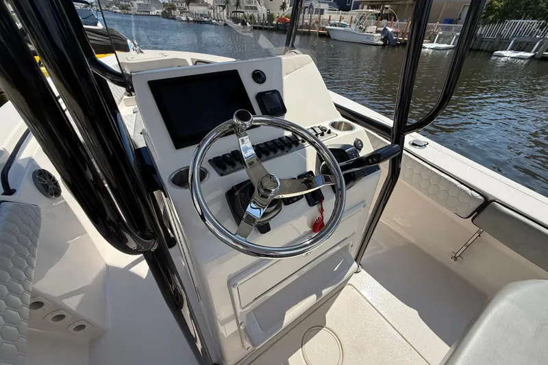 Slide: The Image of 2025 Sea Chaser 22 HFC boat helm with steering wheel and control panel. - 3