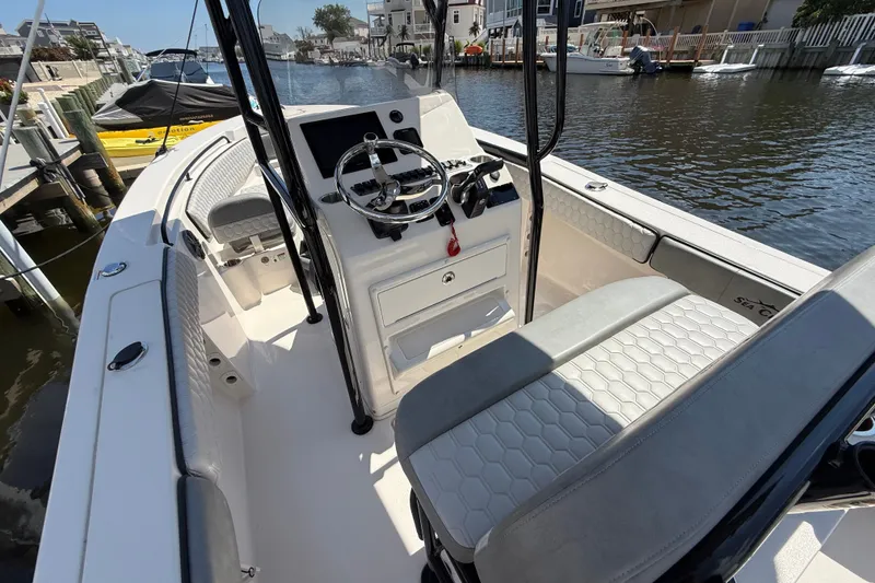 Slide: The Image of 2025 Sea Chaser 22 HFC boat interior with steering console and seating. - 10