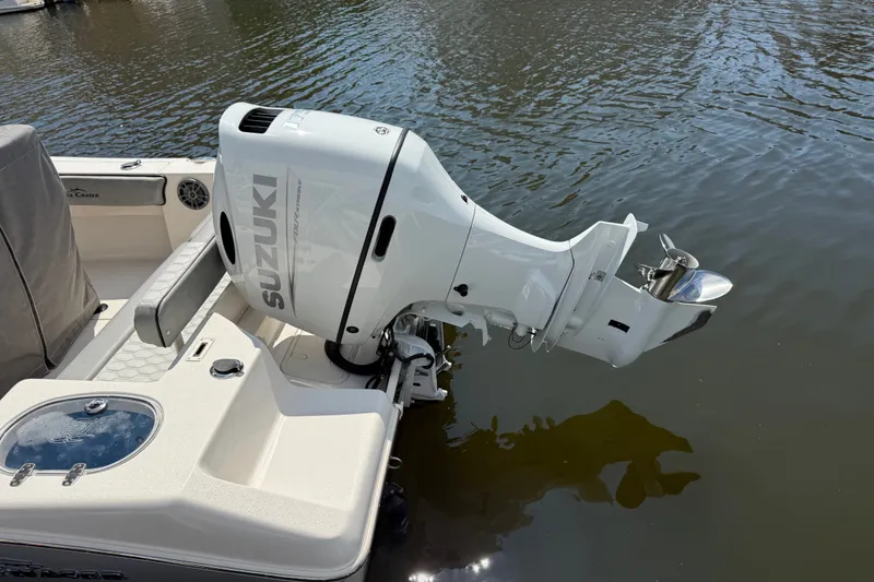 Slide: The Image of Outboard motor on 2025 Sea Chaser 22 HFC boat, docked on calm water. - 8