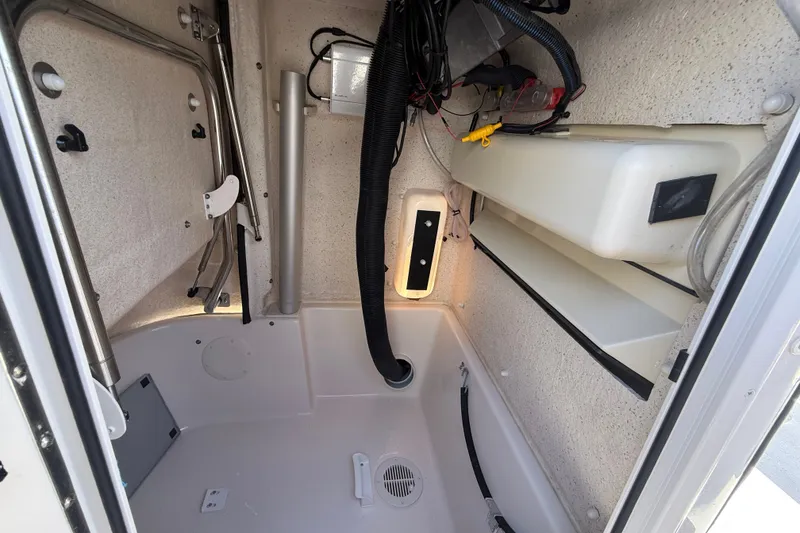 Slide: The Image of Interior view of 2025 Sea Chaser 22 HFC boat compartment with wiring and storage. - 5