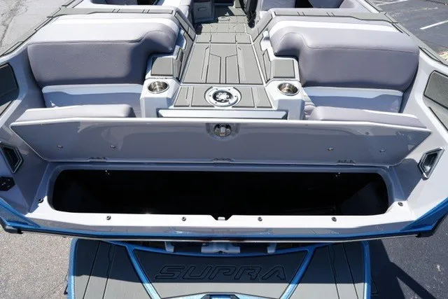 Slide: The Image of 2027 Supra SL boat interior with open storage compartment and seating area. - 19