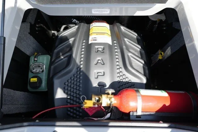 Slide: The Image of Engine compartment of a 2027 Supra SL with visible fire extinguisher and components. - 21