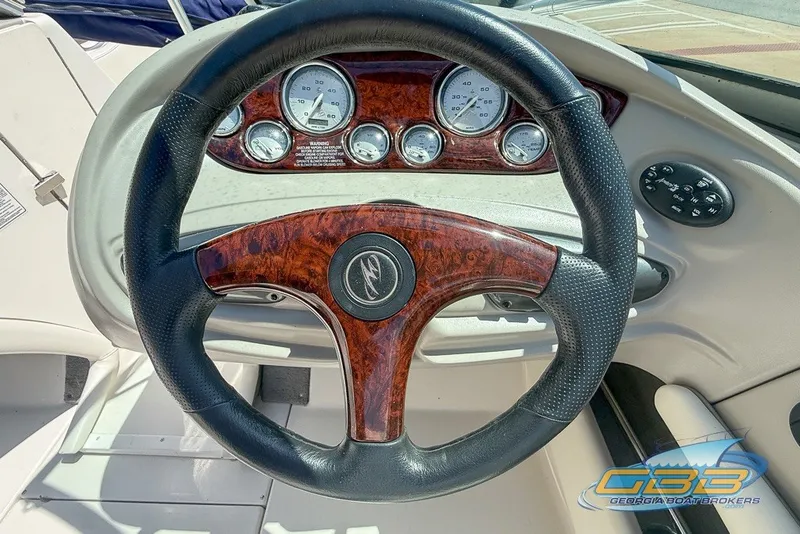 Slide: The Image of Steering wheel and dashboard of 2005 Monterey 228SI Montura Bowrider boat. - 13