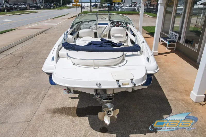 Slide: The Image of 2005 Monterey 228SI Montura Bowrider parked on pavement near a building. - 3