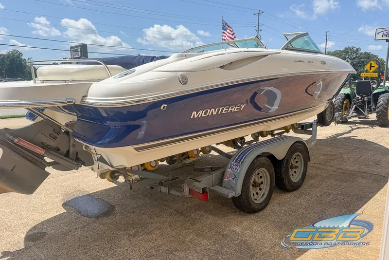 Slide: The Image of 2005 Monterey 228SI Montura Bowrider on trailer, blue and white, sunny day. - 14