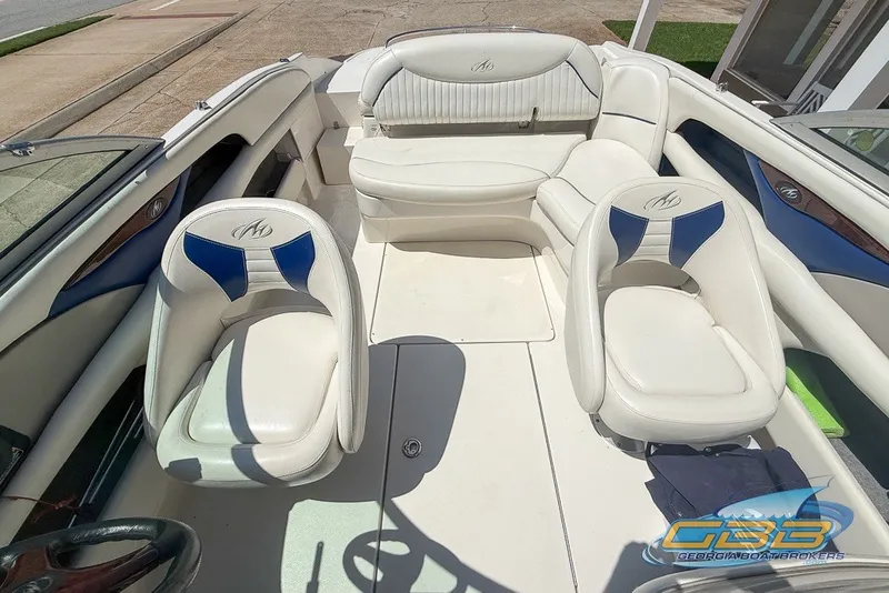 Slide: The Image of 2005 Monterey 228SI Montura Bowrider interior with white and blue seating. - 21