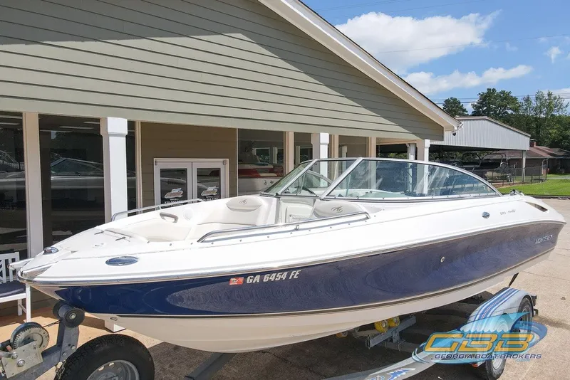 Slide: The Image of 2005 Monterey 228SI Montura Bowrider boat displayed outdoors on a trailer. - 1