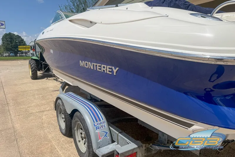 Slide: The Image of 2005 Monterey 228SI Montura Bowrider on trailer, blue and white design, side view. - 12