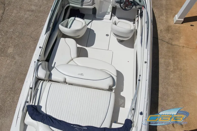 Slide: The Image of 2005 Monterey 228SI Montura Bowrider interior with white seating and steering wheel. - 6