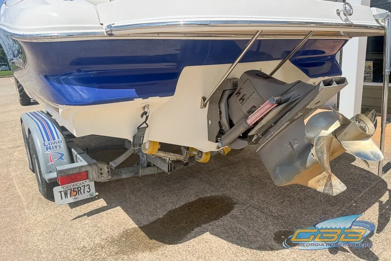 Slide: The Image of Rear view of 2005 Monterey 228SI Montura Bowrider on trailer, showcasing propeller and hull. - 23