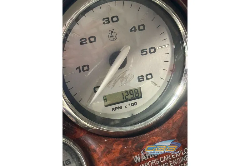 Slide: The Image of Close-up of a 2005 Monterey 228SI Montura Bowrider tachometer displaying 1299 RPM. - 16