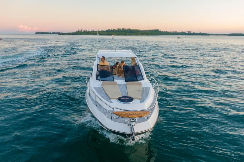 Slide: The Image of Luxury Hanover 375 yacht cruising on serene waters at sunset, 2026 model. - 4
