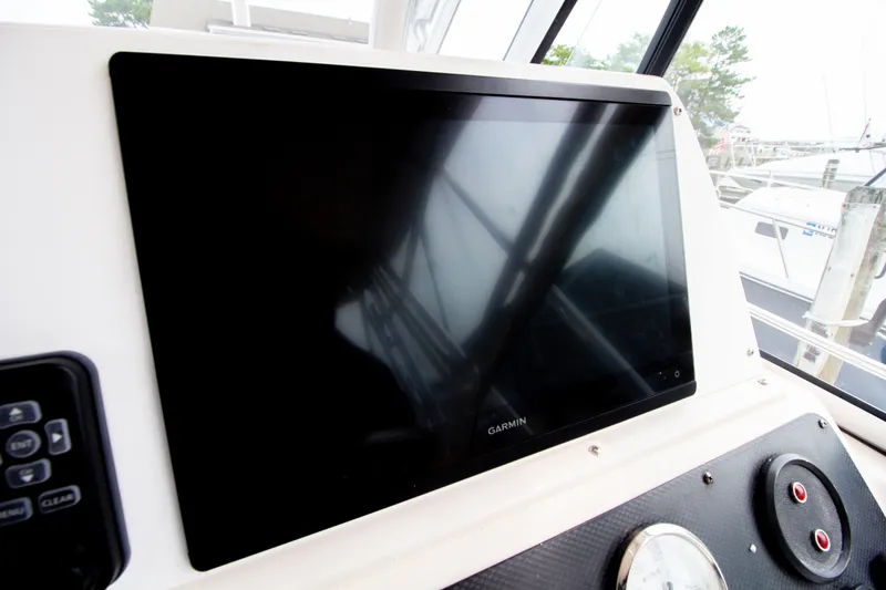 Slide: The Image of The image shows a Garmin navigation system on a Grady-White Marlin 300 boat. - 46
