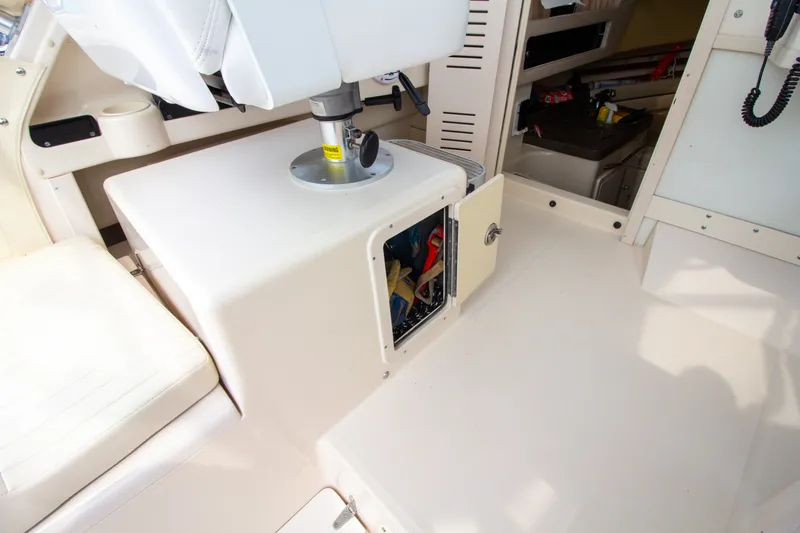 Slide: The Image of The interior of a 2004 Grady-White Marlin 300 shows an open storage compartment area. - 41