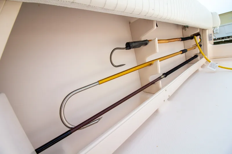 Slide: The Image of Fishing rod holders in the storage compartment of a 2004 Grady-White Marlin 300 boat. - 28