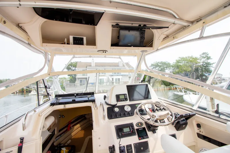 Slide: The Image of The cockpit of a 2004 Grady-White Marlin 300 with helm and electronics. - 44