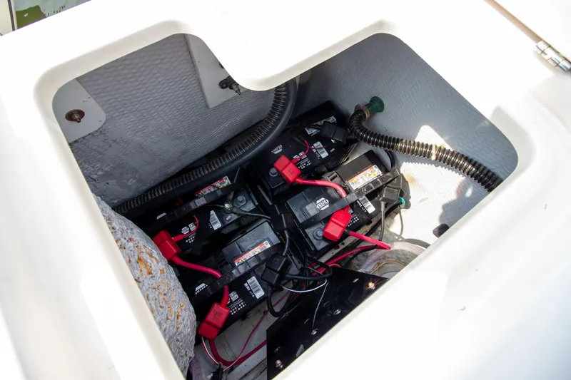 Slide: The Image of Battery compartment of a 2004 Grady-White Marlin 300 boat with multiple batteries and cables. - 23