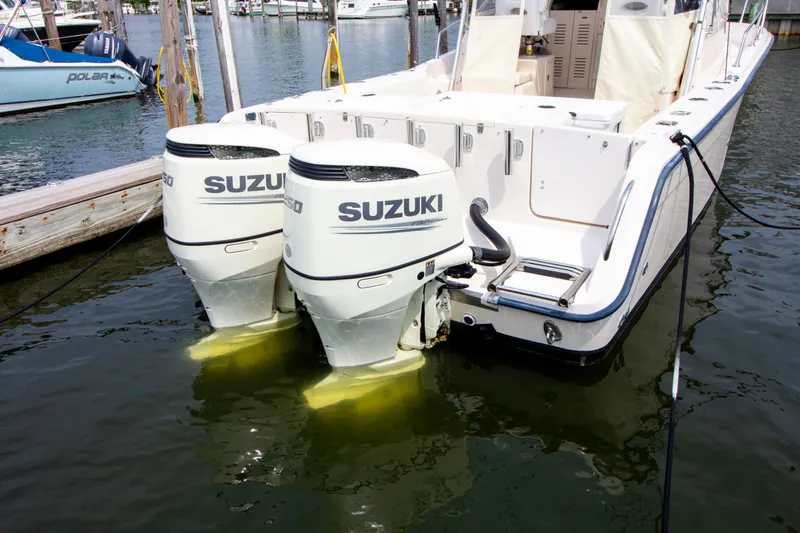 Slide: The Image of A 2004 Grady-White Marlin 300 with twin Suzuki outboard engines in the water. - 8