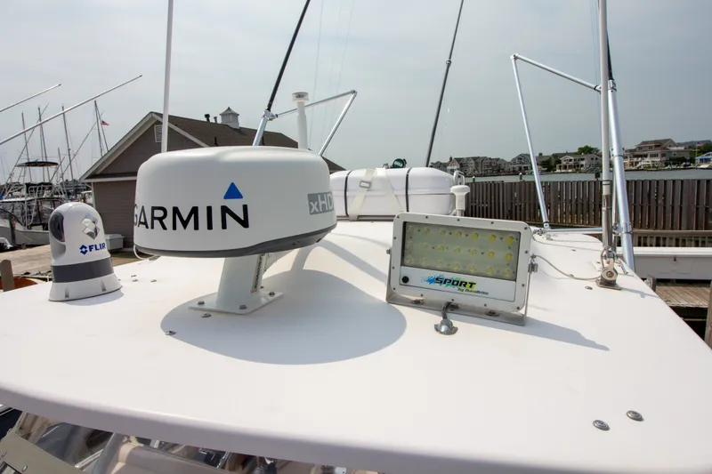 Slide: The Image of The image shows the roof of a Grady-White Marlin 300 boat with Garmin and FLIR equipment. - 18