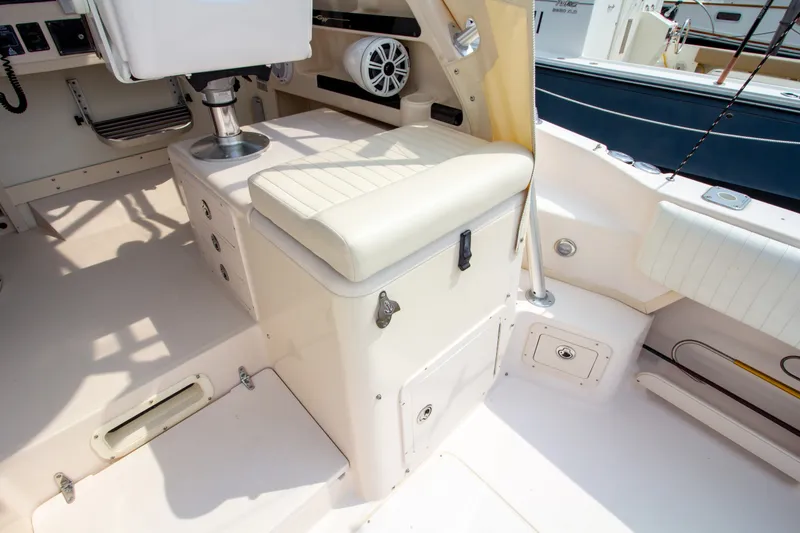 Slide: The Image of The image shows the cockpit of a 2004 Grady-White Marlin 300 with beige upholstery. - 33