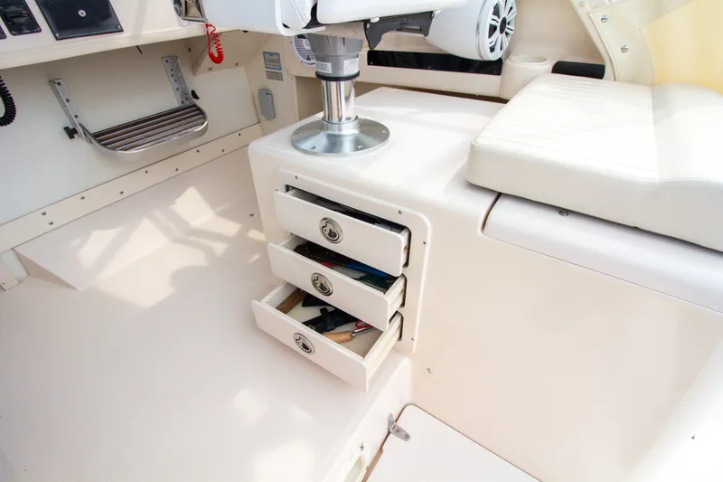 Slide: The Image of The image shows the interior of a 2004 Grady-White Marlin 300 boat with open drawers. - 40