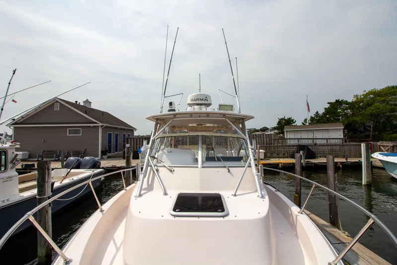 Slide: The Image of A 2004 Grady-White Marlin 300 docked, featuring a spacious foredeck area. - 15