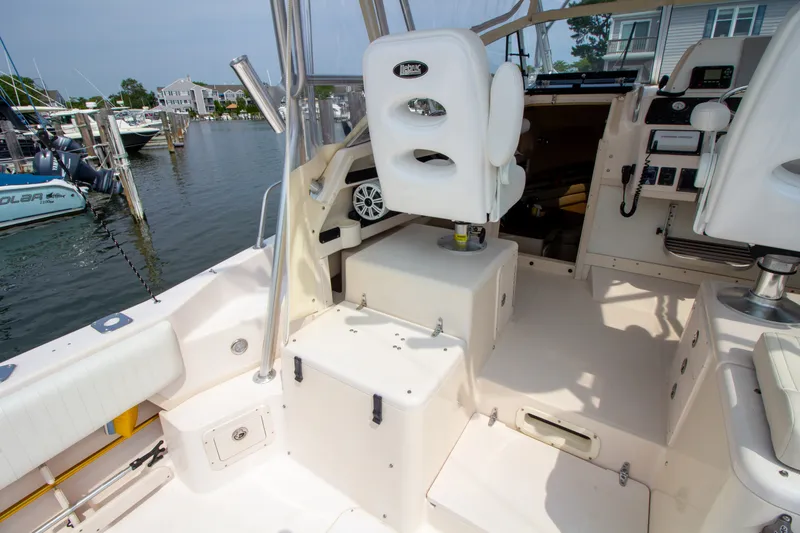 Slide: The Image of The image shows the cockpit of a 2004 Grady-White Marlin 300, featuring white seats and a helm station. - 35