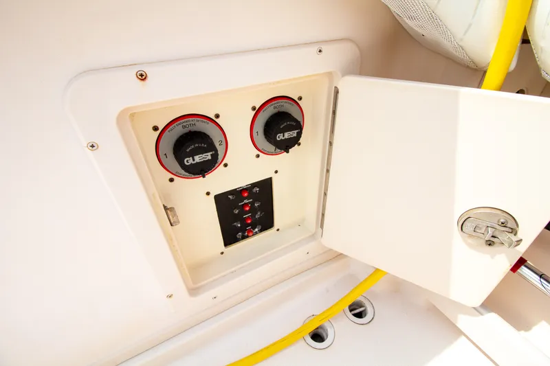 Slide: The Image of An electrical panel with two rotary switches and several toggle switches in a boat. - 24