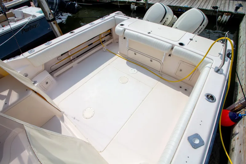 Slide: The Image of The image shows the spacious cockpit of a Grady-White Marlin 300 boat docked at a pier. - 19