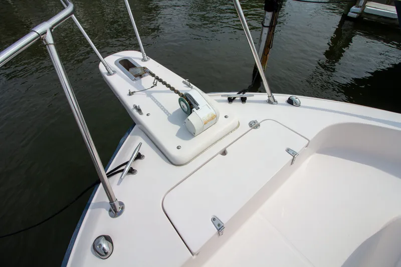 Slide: The Image of The image shows the bow of a 2004 Grady-White Marlin 300 boat with an anchor windlass. - 12