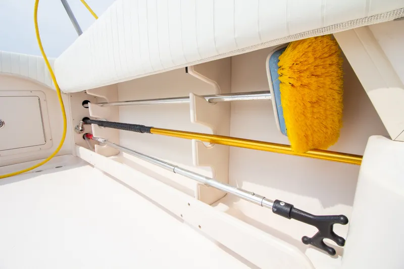 Slide: The Image of Storage area with cleaning tools and fishing rod holders on a boat. - 29