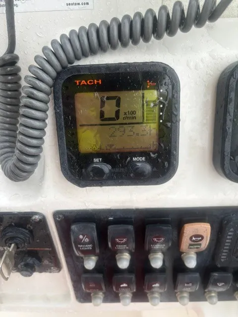 Slide: The Image of A tachometer and switches on a boat, covered with water droplets. - 11