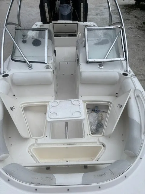 Slide: The Image of The image shows the cockpit of an Edgewater 245CX Crossover with open storage compartments. - 8