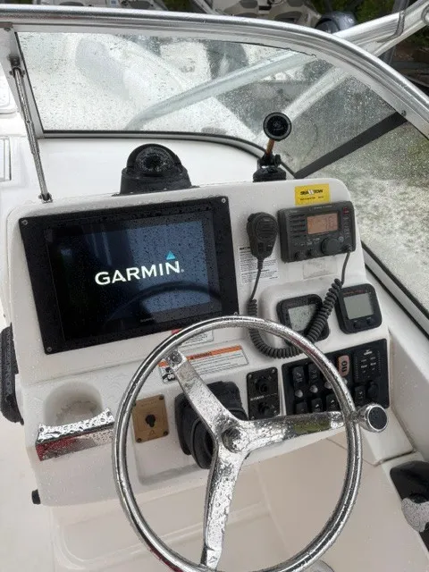 Slide: The Image of The image shows the helm of an Edgewater 245CX Crossover with a Garmin navigation system. - 10