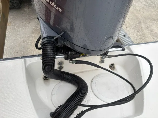 Slide: The Image of An outboard motor is mounted on a boat, connected with hoses and cables. - 3