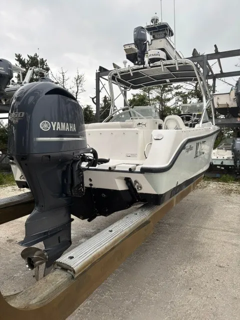 Slide: The Image of A 2010 Edgewater 245CX Crossover boat with a Yamaha outboard motor, on a dry dock. - 2