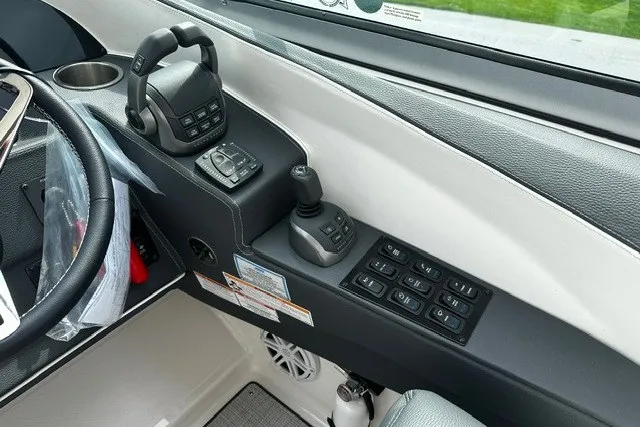 Slide: The Image of Control panel of a 2027 Regal 3300 boat with joystick and throttle controls. - 12