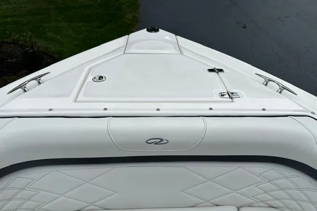 Slide: The Image of Bow of a 2027 Regal 3300 boat with sleek white design and cushioned seating. - 32
