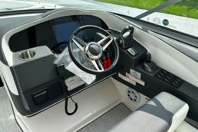 Slide: The Image of Cockpit of 2027 Regal 3300 boat with steering wheel and control panel. - 11