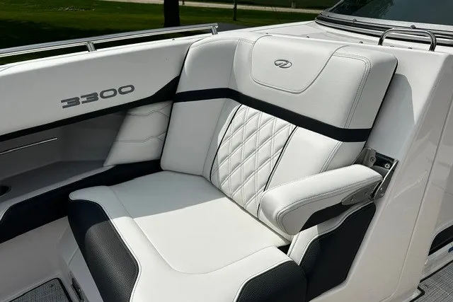 Slide: The Image of Luxurious seating on a 2027 Regal 3300 boat, featuring elegant white and black upholstery. - 28