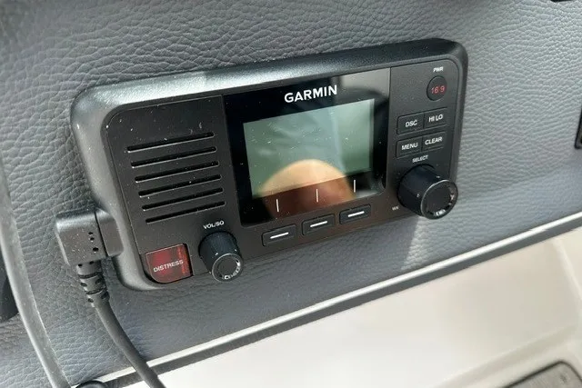 Slide: The Image of Garmin marine radio installed on a 2027 Regal 3300 boat dashboard. - 15