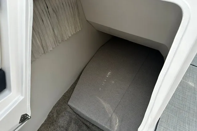 Slide: The Image of 2027 Regal 3300 cabin interior with cushioned seating and carpeted flooring. - 29