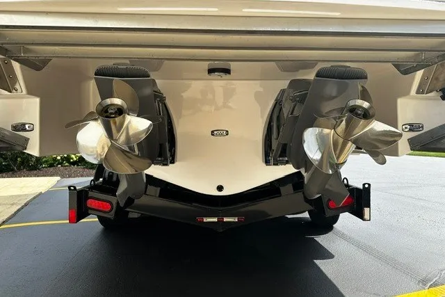 Slide: The Image of Rear view of 2027 Regal 3300 boat with dual propellers on a trailer. - 5