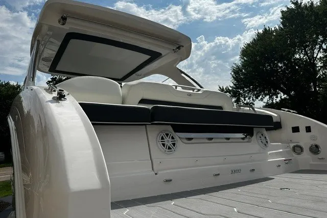 Slide: The Image of 2027 Regal 3300 boat with sleek design, spacious seating, and modern features under a sunny sky. - 6