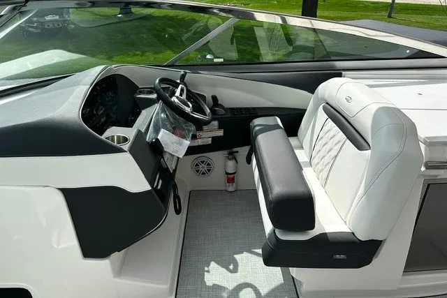 Slide: The Image of 2027 Regal 3300 boat cockpit with steering wheel, white seating, and modern dashboard. - 10