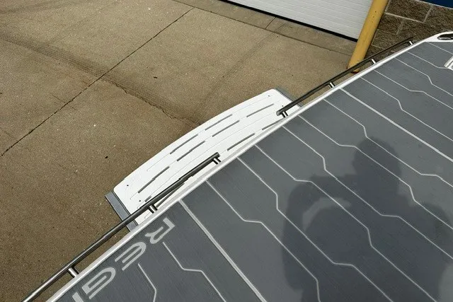 Slide: The Image of 2027 Regal 3300 boat with solar panels on deck, docked on concrete surface. - 42