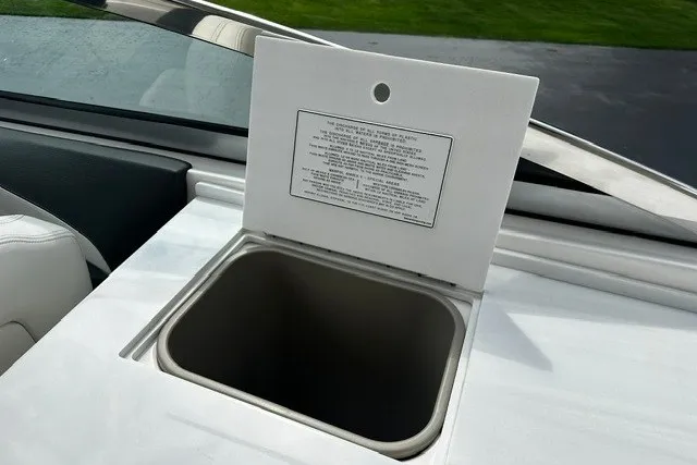 Slide: The Image of Open storage compartment on 2027 Regal 3300 boat with instruction label. - 22