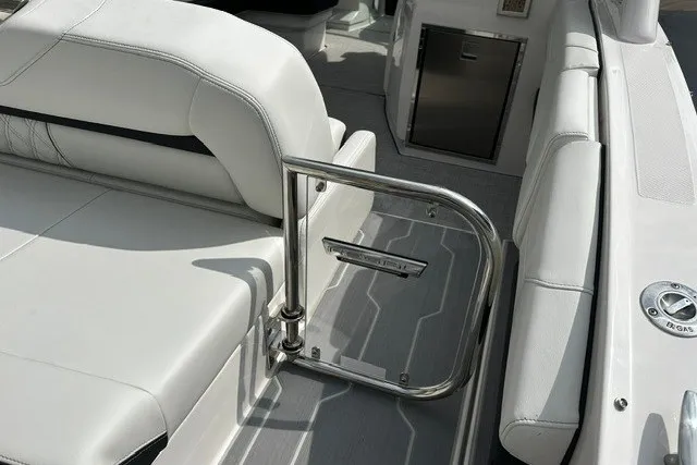 Slide: The Image of 2027 Regal 3300 boat interior with white seating and stainless steel railing. - 7