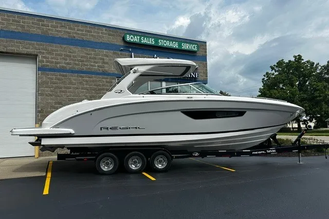 Slide: The Image of 2027 Regal 3300 boat on trailer at dealership, showcasing sleek design and modern features. - 1